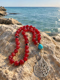 Glass agate prayer beads with a nickel pendant.