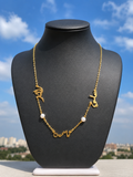 Stainless steel chain with brass name pendants.