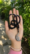 Alabaster prayer beads with a nickel pendant.