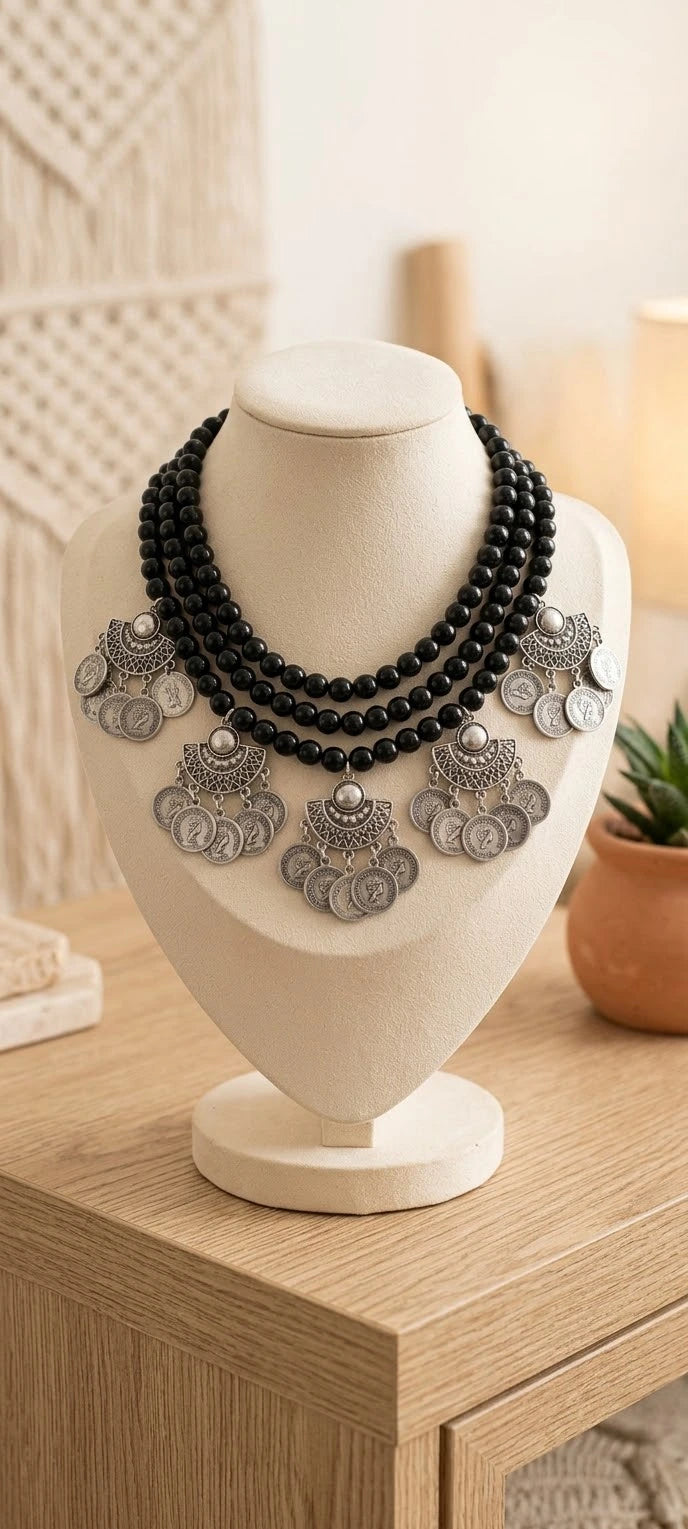 Alabaster stone necklace with nickel pendants.